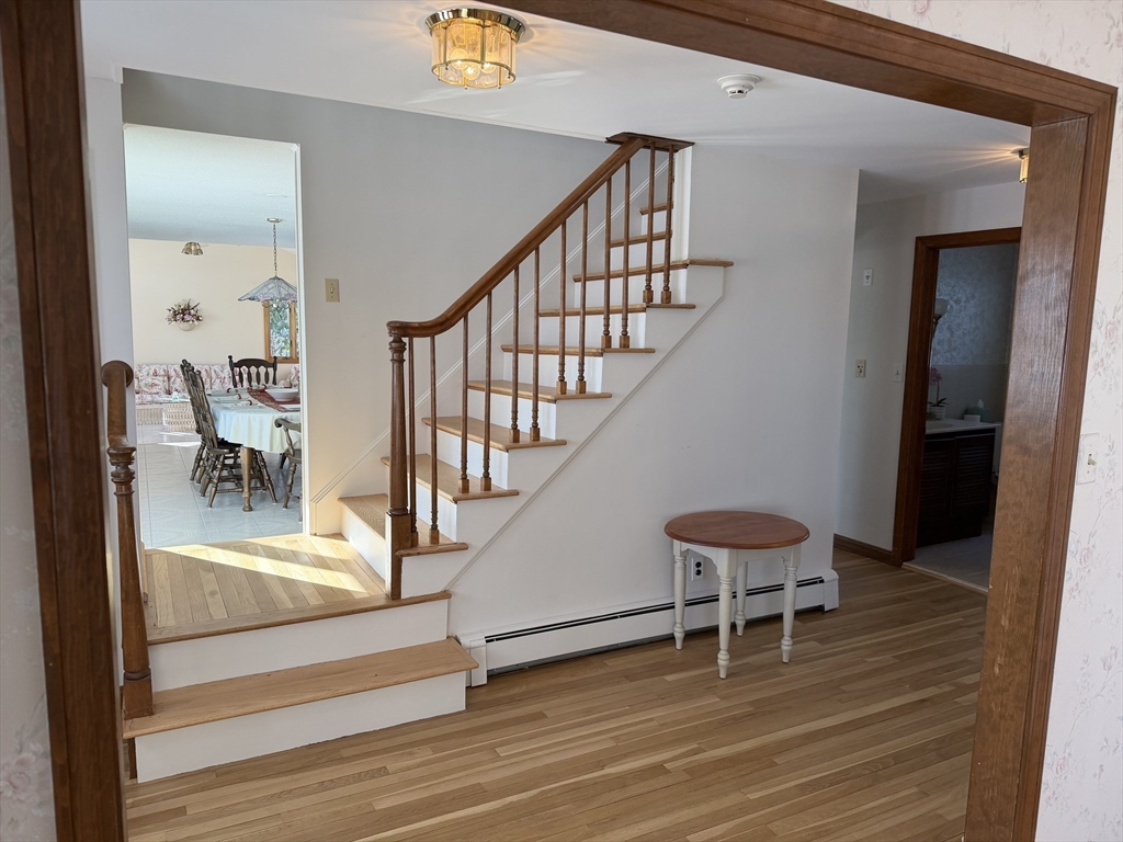 24 Flume Road Gloucester, MA 01930 - Photo 5 of 40 a view of a hallway with wooden floor and furniture
