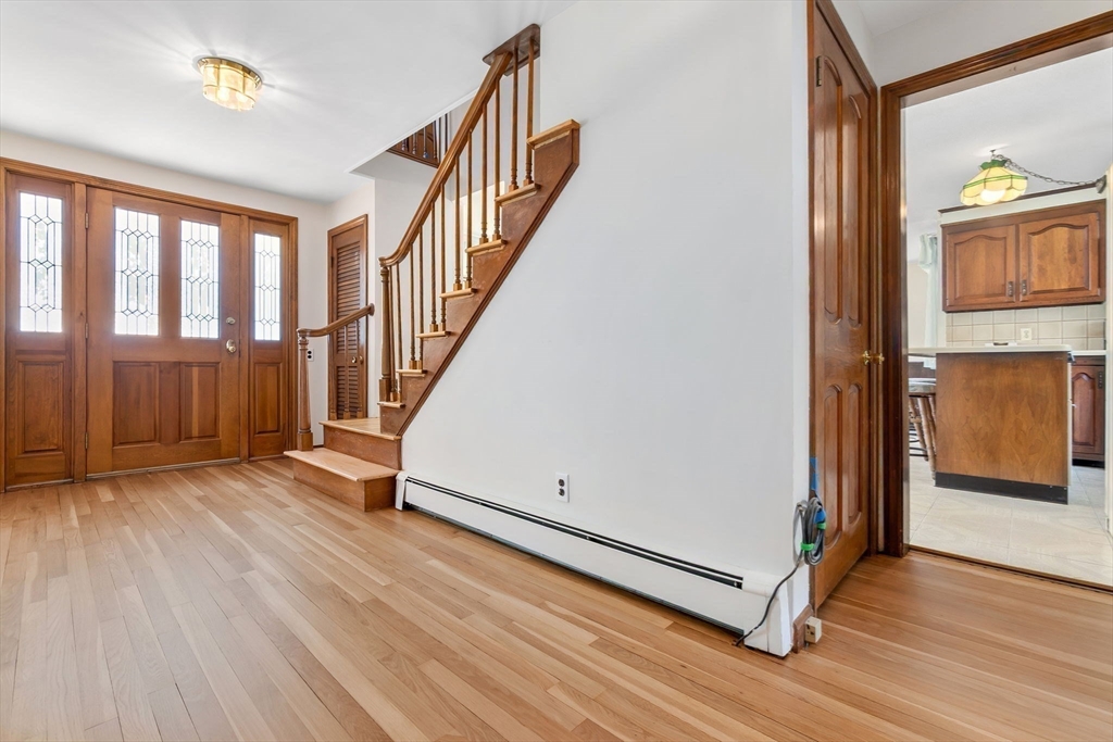 24 Flume Road Gloucester, MA 01930 - Photo 6 of 40 a view of a hallway with wooden floor and staircase