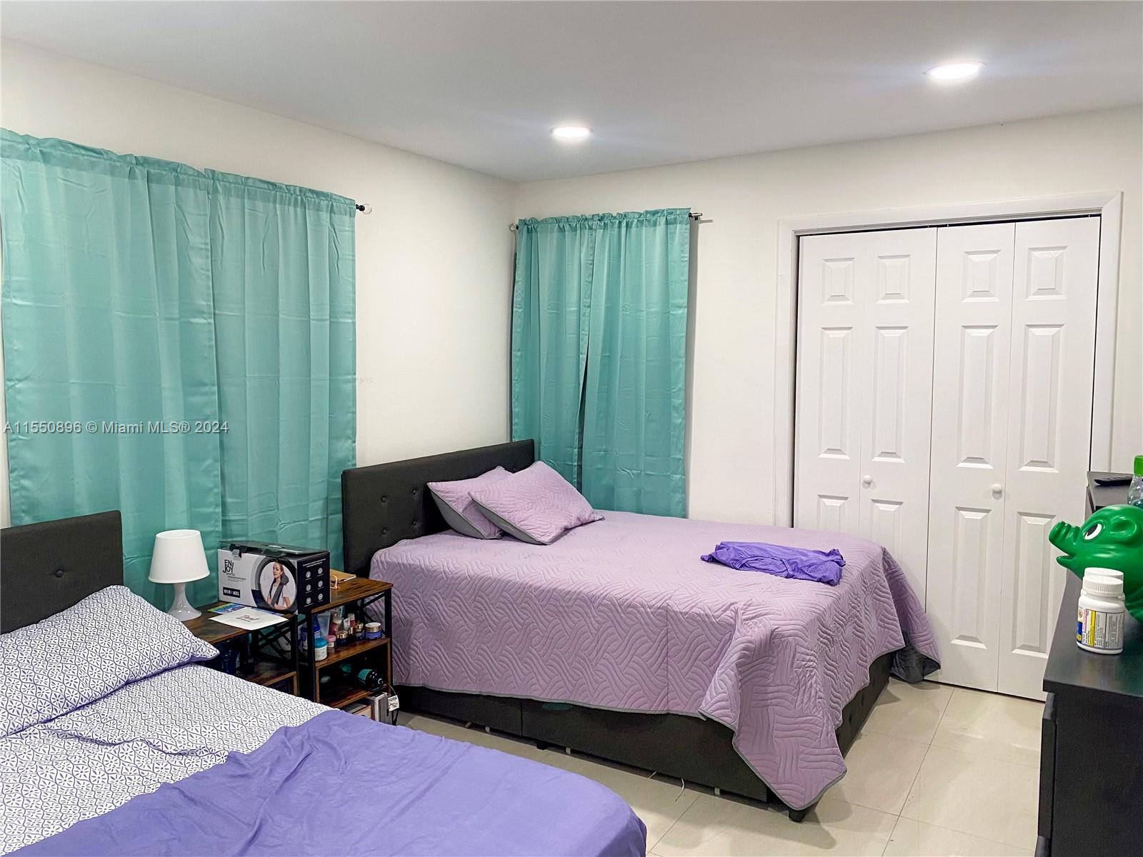 11032 Southwest 5th Street Sweetwater, FL 33174 - Photo 11 of 24 a bedroom with a bed and a closet