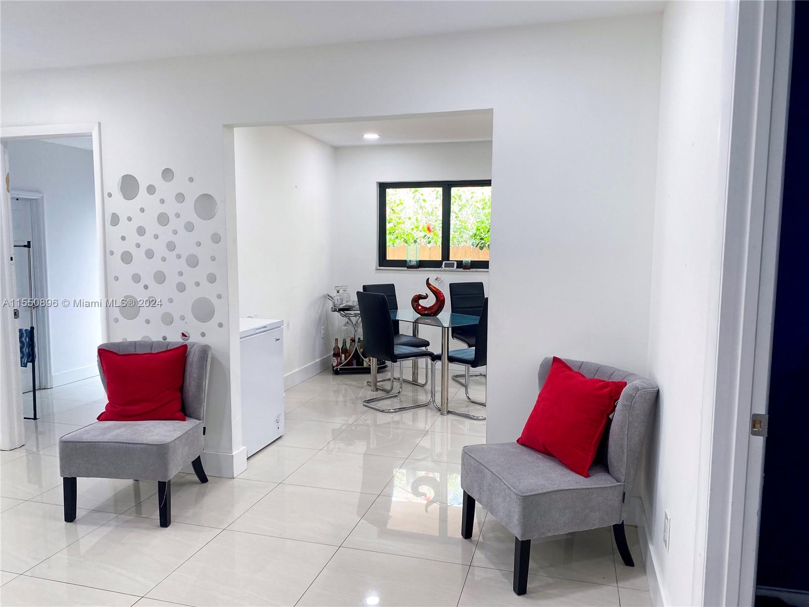 11032 Southwest 5th Street Sweetwater, FL 33174 - Photo 17 of 24 a living room with furniture a rug and a chair