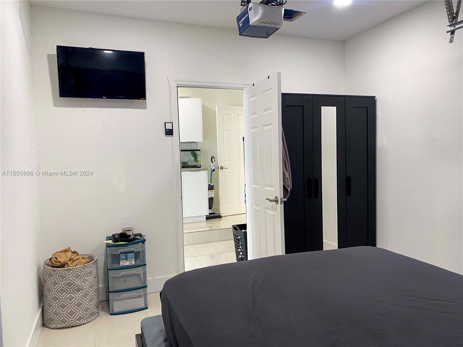 11032 Southwest 5th Street Sweetwater, FL 33174 - Photo 19 of 24 a bedroom with a bed and a television