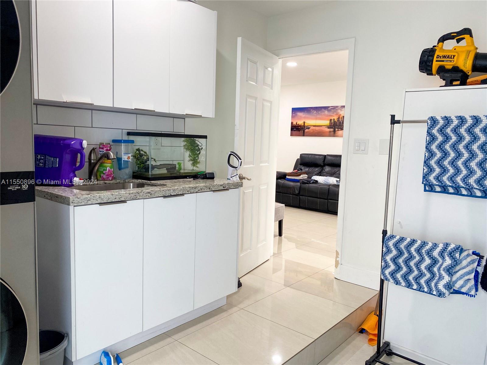 11032 Southwest 5th Street Sweetwater, FL 33174 - Photo 20 of 24 a kitchen with a sink and cabinets