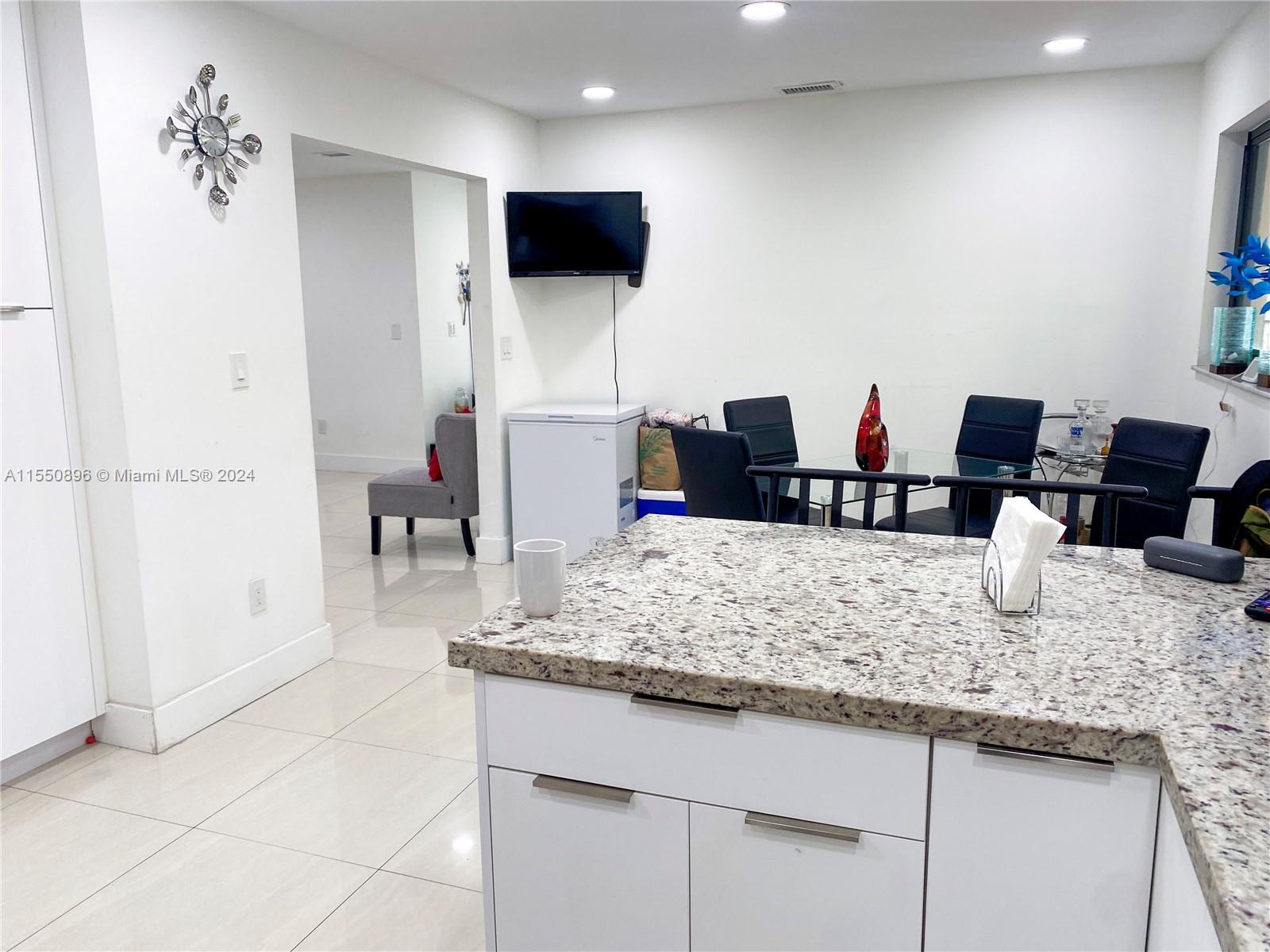 11032 Southwest 5th Street Sweetwater, FL 33174 - Photo 23 of 24 a kitchen with cabinets and chairs