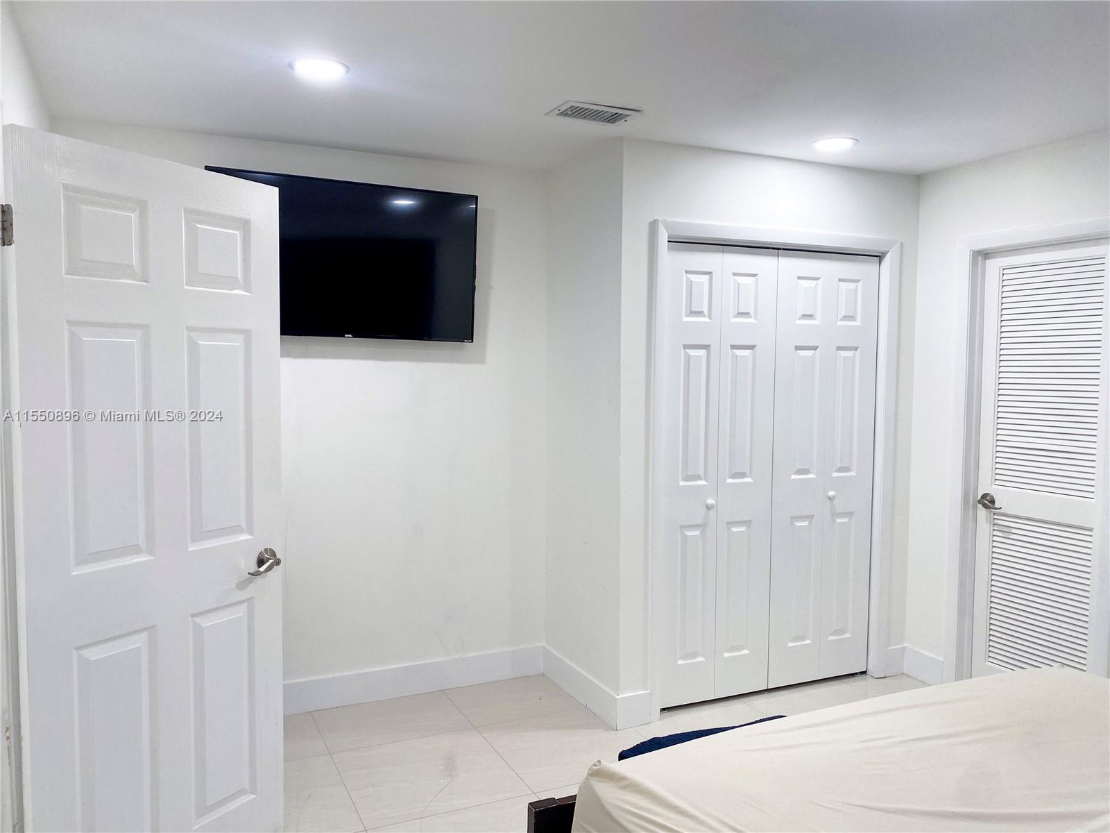 11032 Southwest 5th Street Sweetwater, FL 33174 - Photo 9 of 24 a view of a livingroom with a flat screen tv
