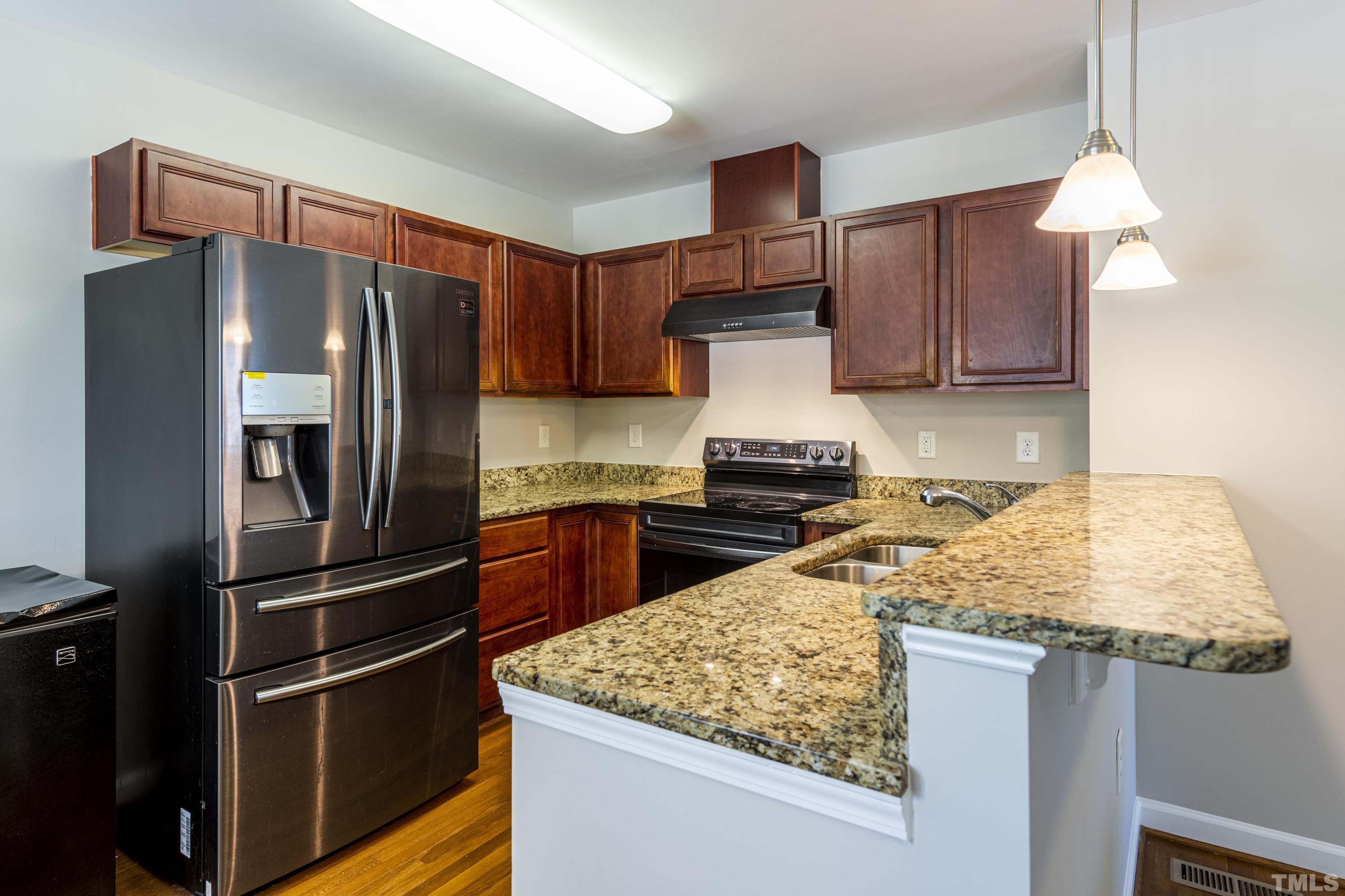 1119 South State Street Raleigh, NC 27601 - Photo 6 of 35 a kitchen with stainless steel appliances granite countertop a refrigerator and a stove