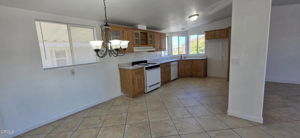 1645 Lime Avenue, Unit 91 Oxnard, CA 93033 - Photo 4 of 17 a kitchen with stainless steel appliances granite countertop a stove a sink and a granite counter tops