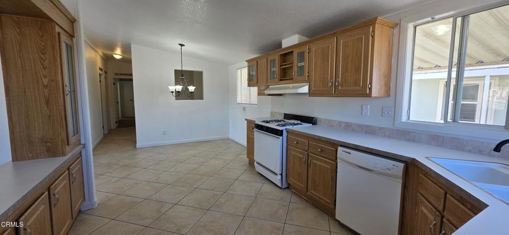 1645 Lime Avenue, Unit 91 Oxnard, CA 93033 - Photo 6 of 17 a kitchen with stainless steel appliances granite countertop a stove a sink and a refrigerator