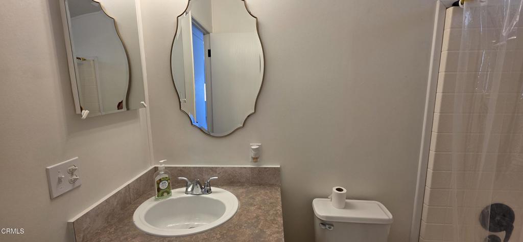 1645 Lime Avenue, Unit 91 Oxnard, CA 93033 - Photo 10 of 17 a bathroom with a sink a toilet and a mirror