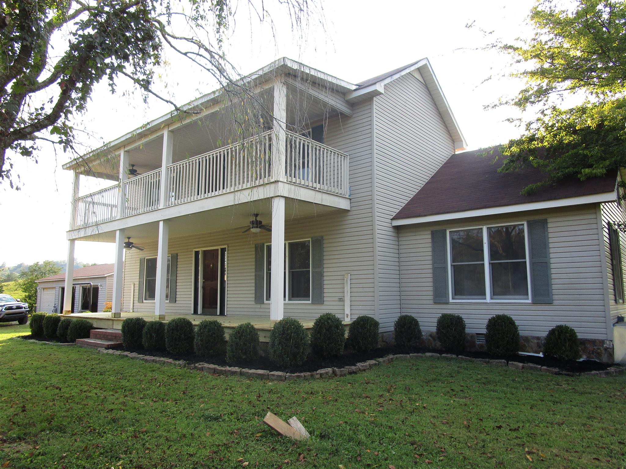 4020 Stella Road Prospect, TN 38477 - Photo 1 of 27 a front view of a house with a garden