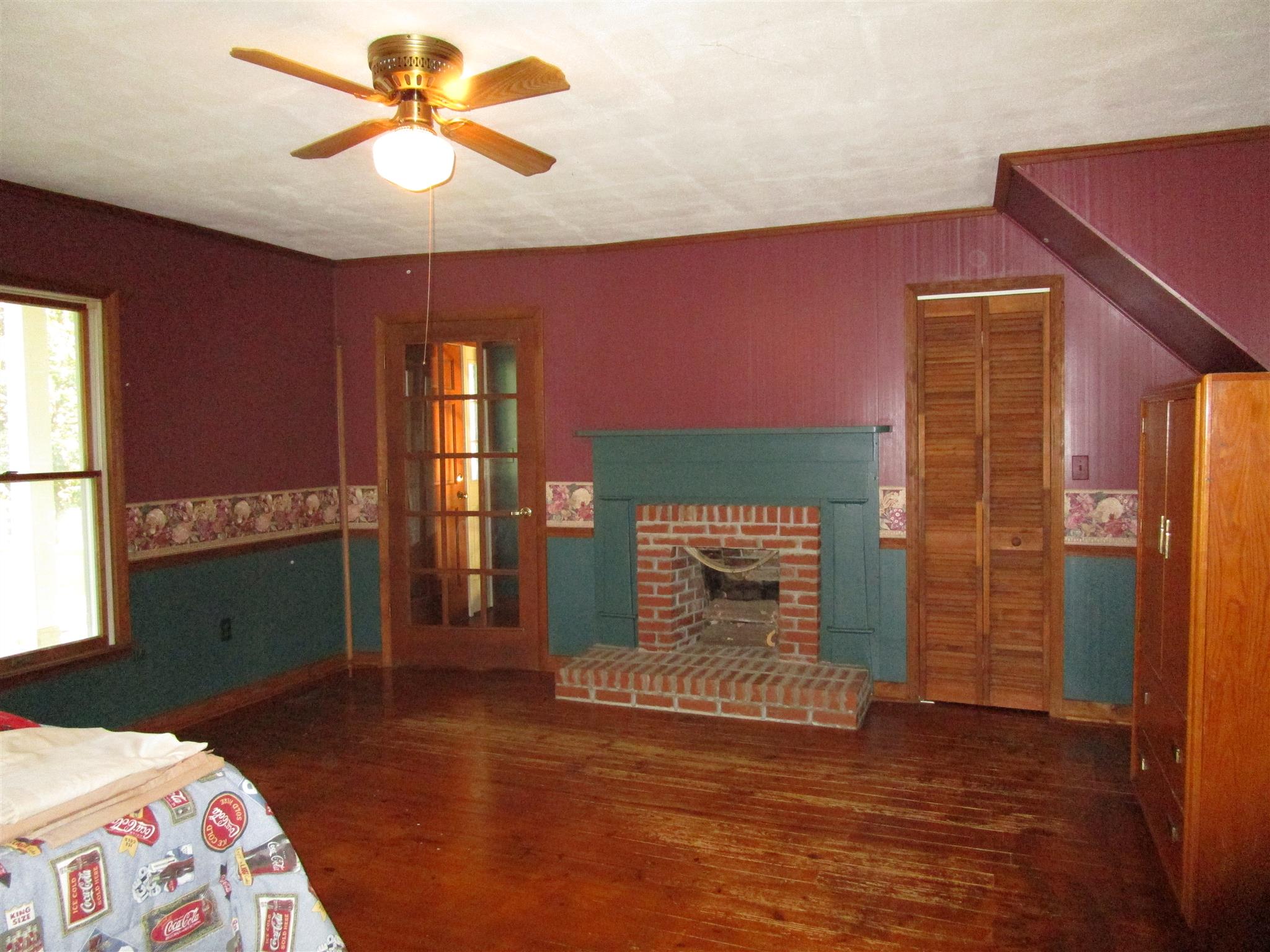 4020 Stella Road Prospect, TN 38477 - Photo 14 of 27 a bedroom with a bed and a fireplace