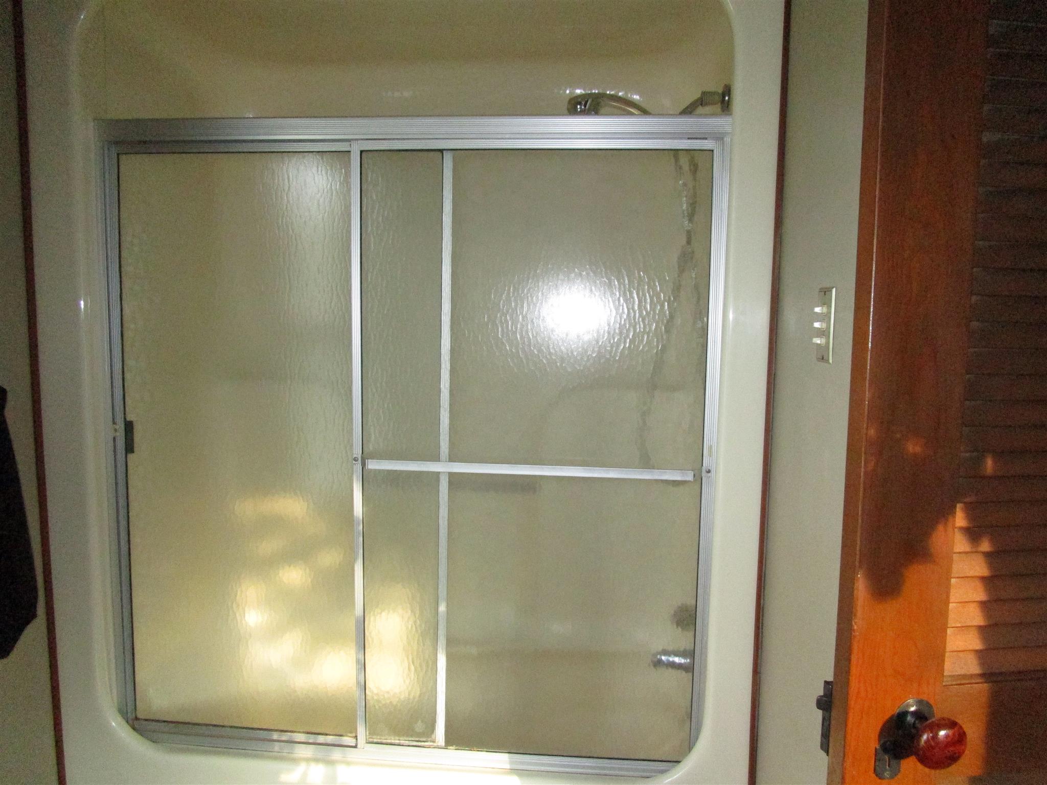 4020 Stella Road Prospect, TN 38477 - Photo 17 of 27 a bathroom with a glass shower door and a window