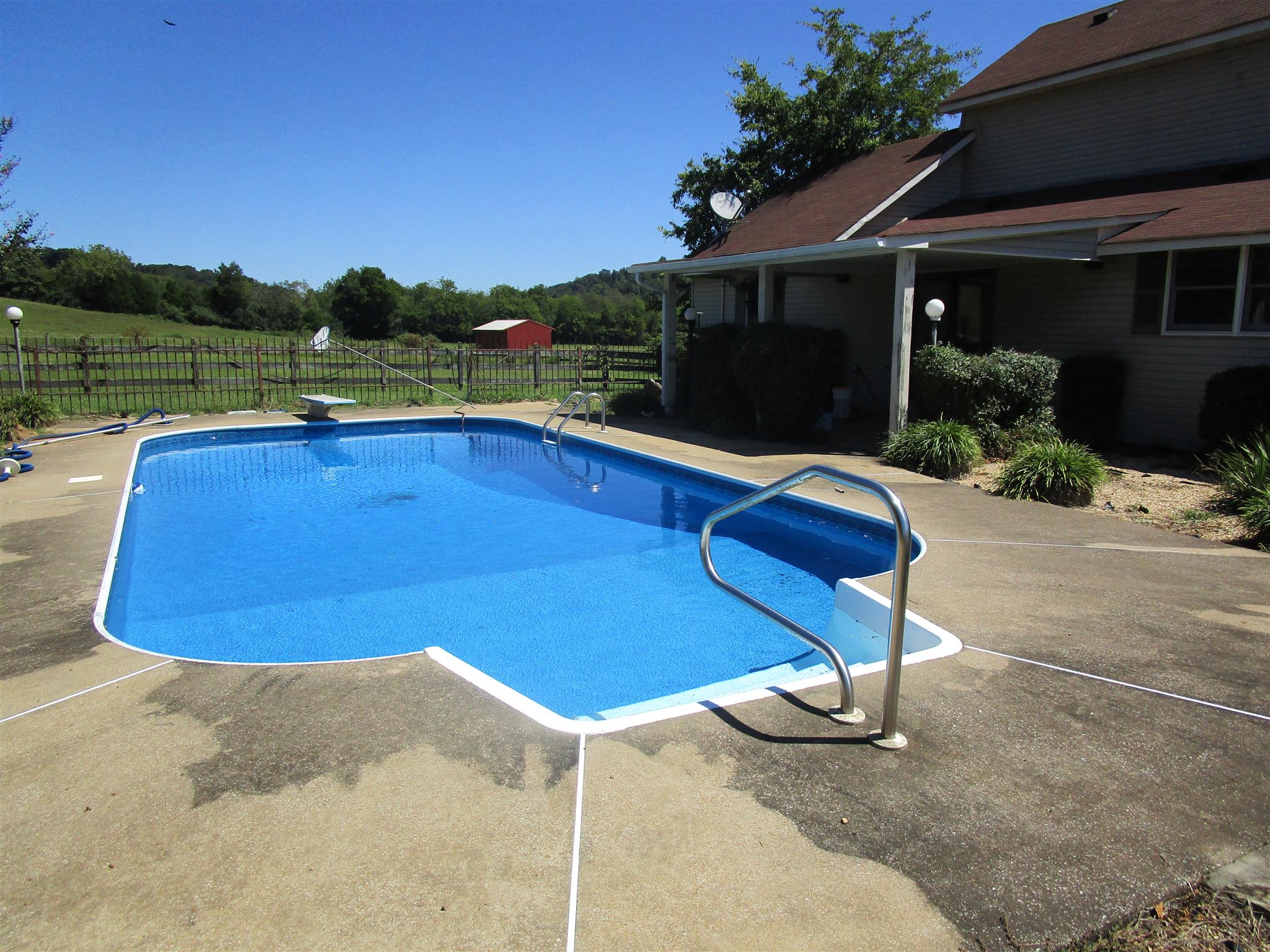 4020 Stella Road Prospect, TN 38477 - Photo 3 of 27 a view of a backyard with lawn chairs under an umbrella