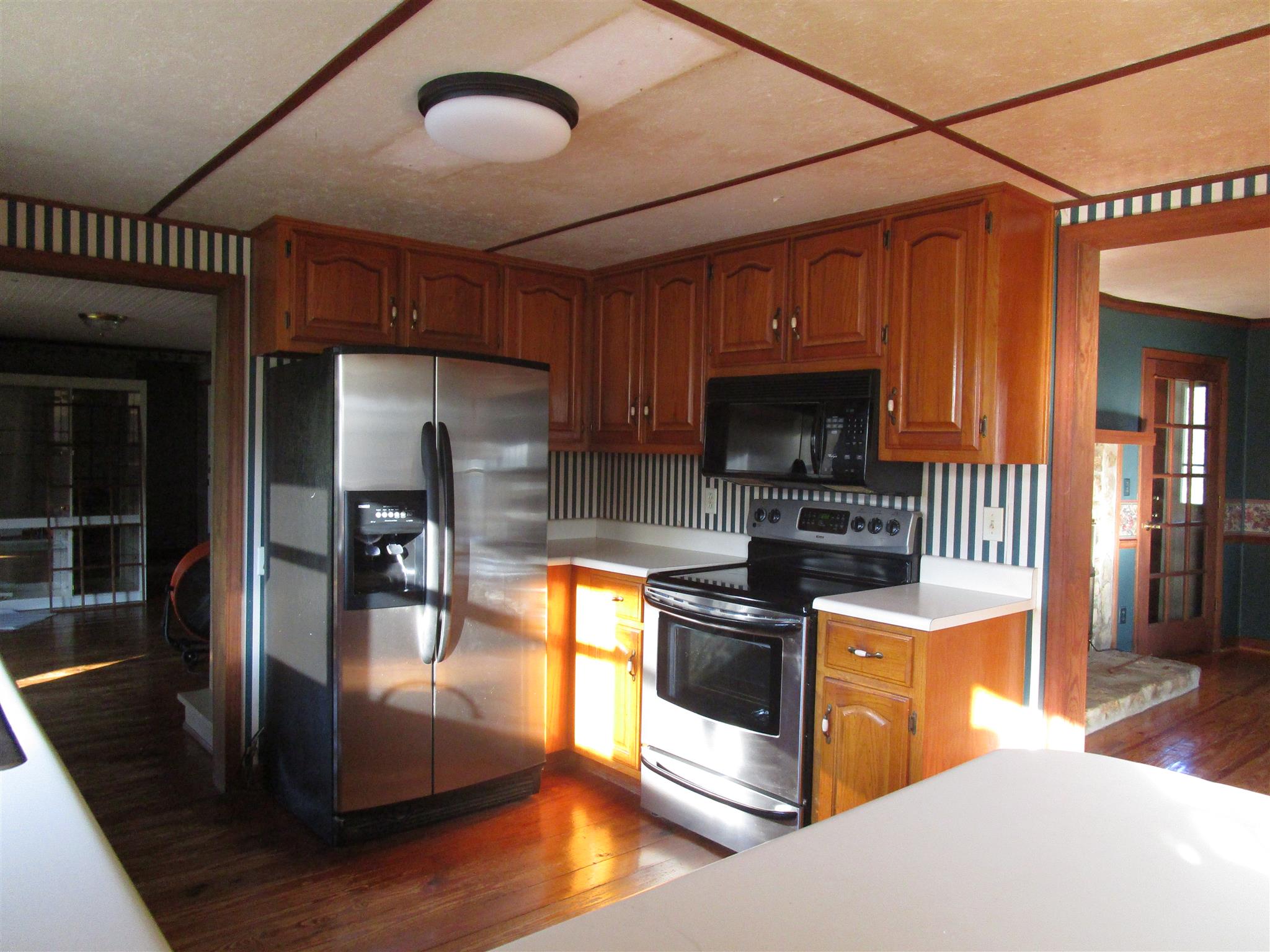 4020 Stella Road Prospect, TN 38477 - Photo 8 of 27 a kitchen with stainless steel appliances granite countertop a stove refrigerator and cabinets