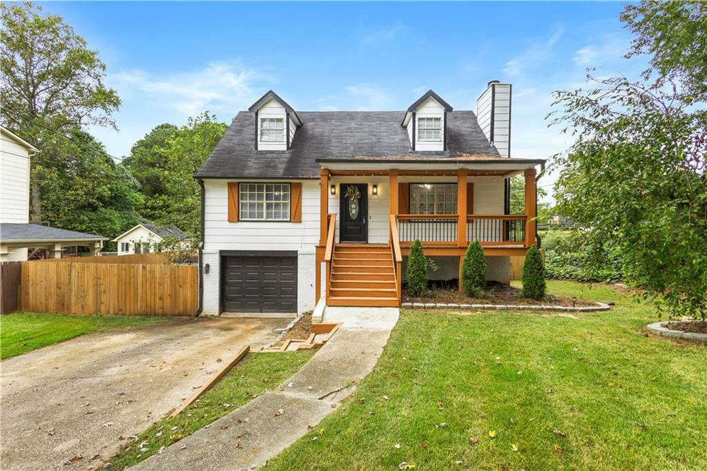 1702 Merry Oak Road Southwest Marietta, GA 30008 - Photo 1 of 1 a front view of a house with a yard and garage