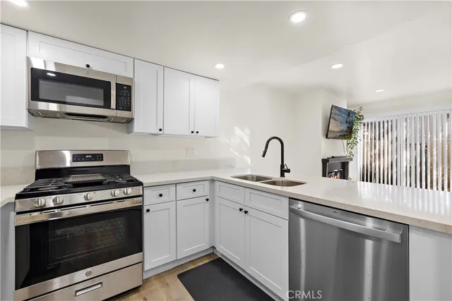 a kitchen with sink a microwave and stove