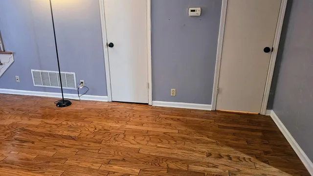 a view of a workspace room with furniture and wooden floor