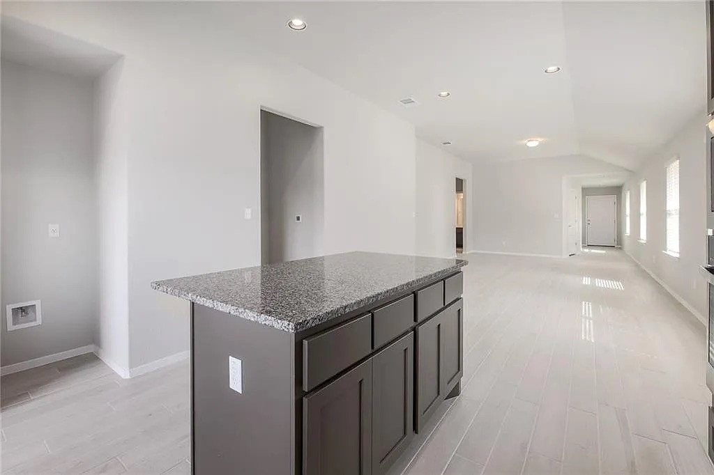 116 River Hills Drive Georgetown, TX 78628 - Photo 12 of 19 a kitchen with stainless steel appliances granite countertop a sink and a refrigerator
