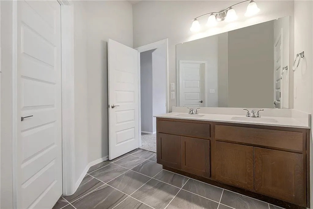 116 River Hills Drive Georgetown, TX 78628 - Photo 15 of 19 a bathroom with a double vanity sink a mirror and a shower