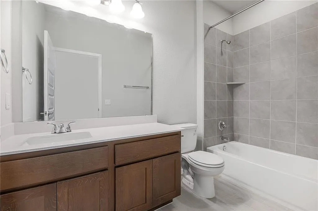 116 River Hills Drive Georgetown, TX 78628 - Photo 18 of 19 a bathroom with a sink a toilet and shower