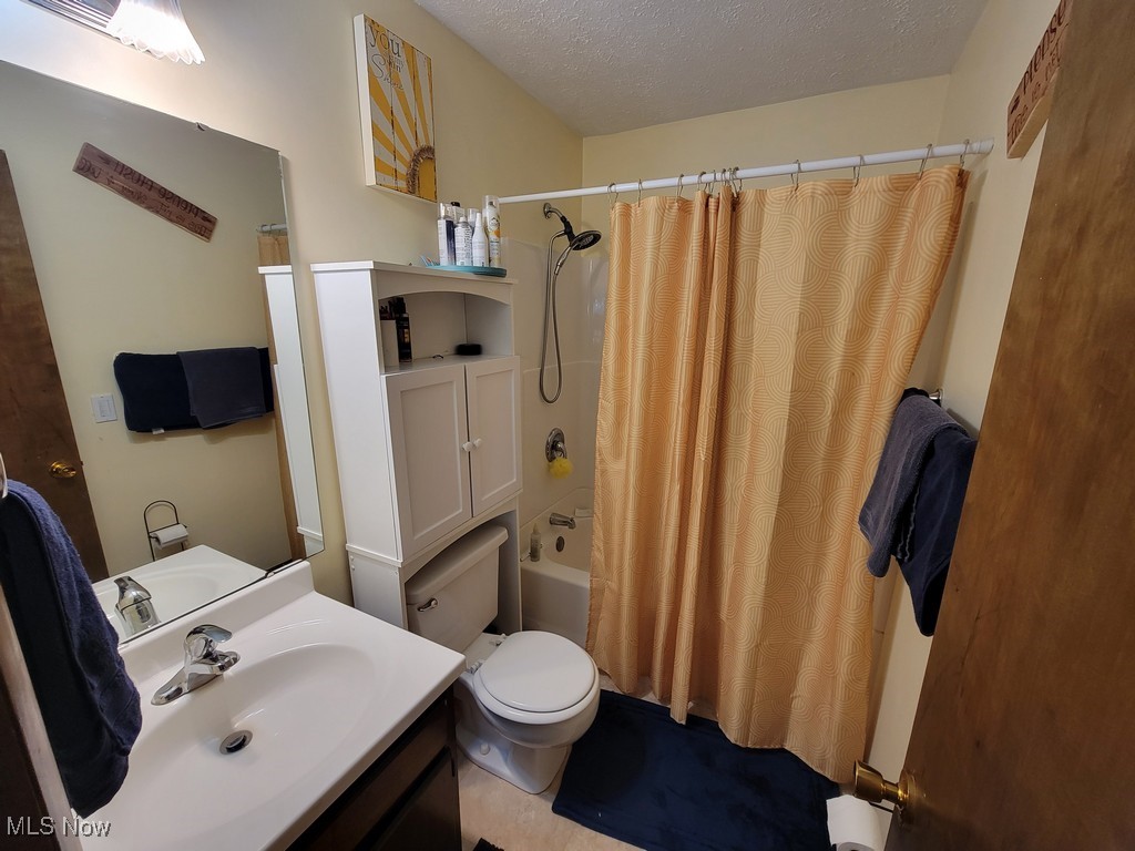 42774 Webster Road Lagrange, OH 44050 - Photo 19 of 37 Full bath featuring a textured ceiling, shower / bath combo, and vanity