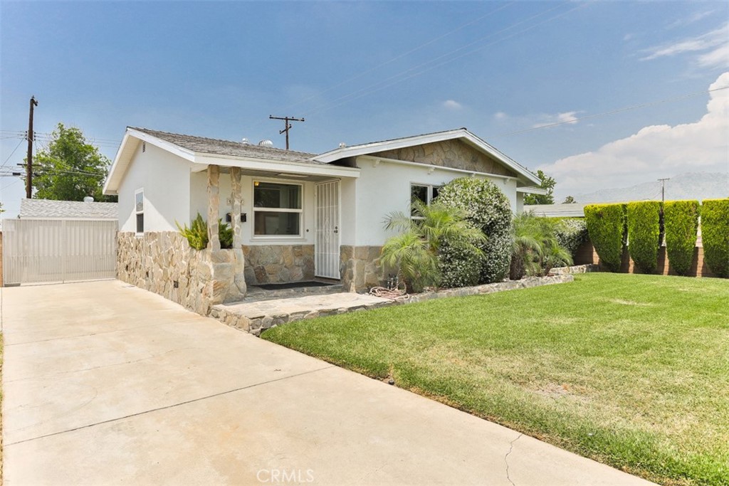 a front view of house with yard and green space