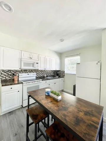 a kitchen with a table and chairs