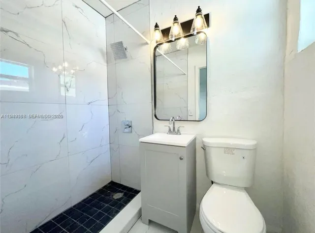 a bathroom with a toilet sink and shower