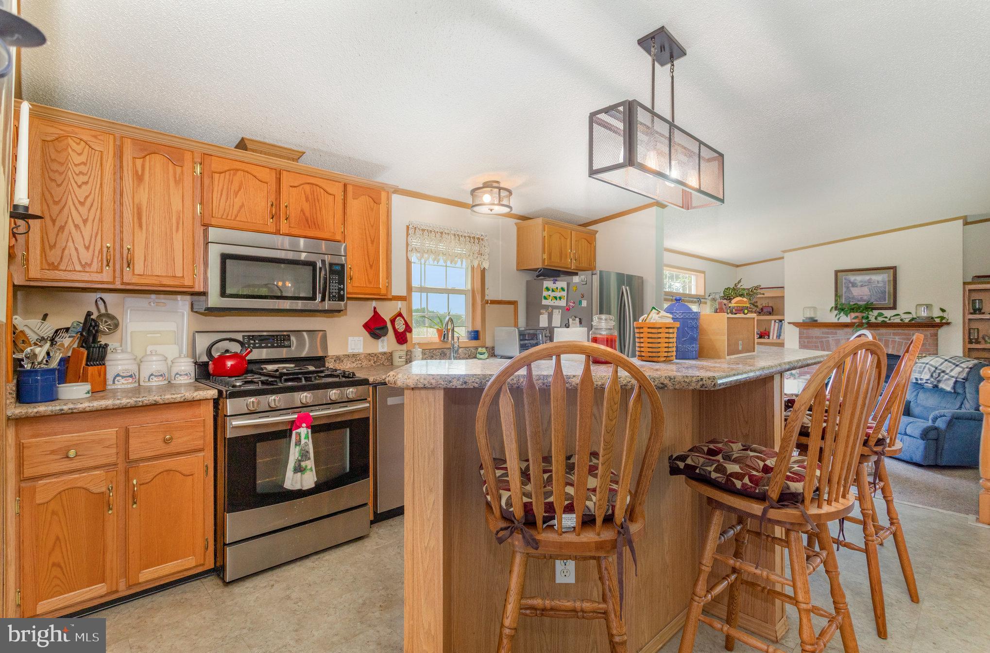 1050 Lisburn Road Wellsville, PA 17365 - Photo 12 of 35 a kitchen with stainless steel appliances kitchen island granite countertop a stove and a sink