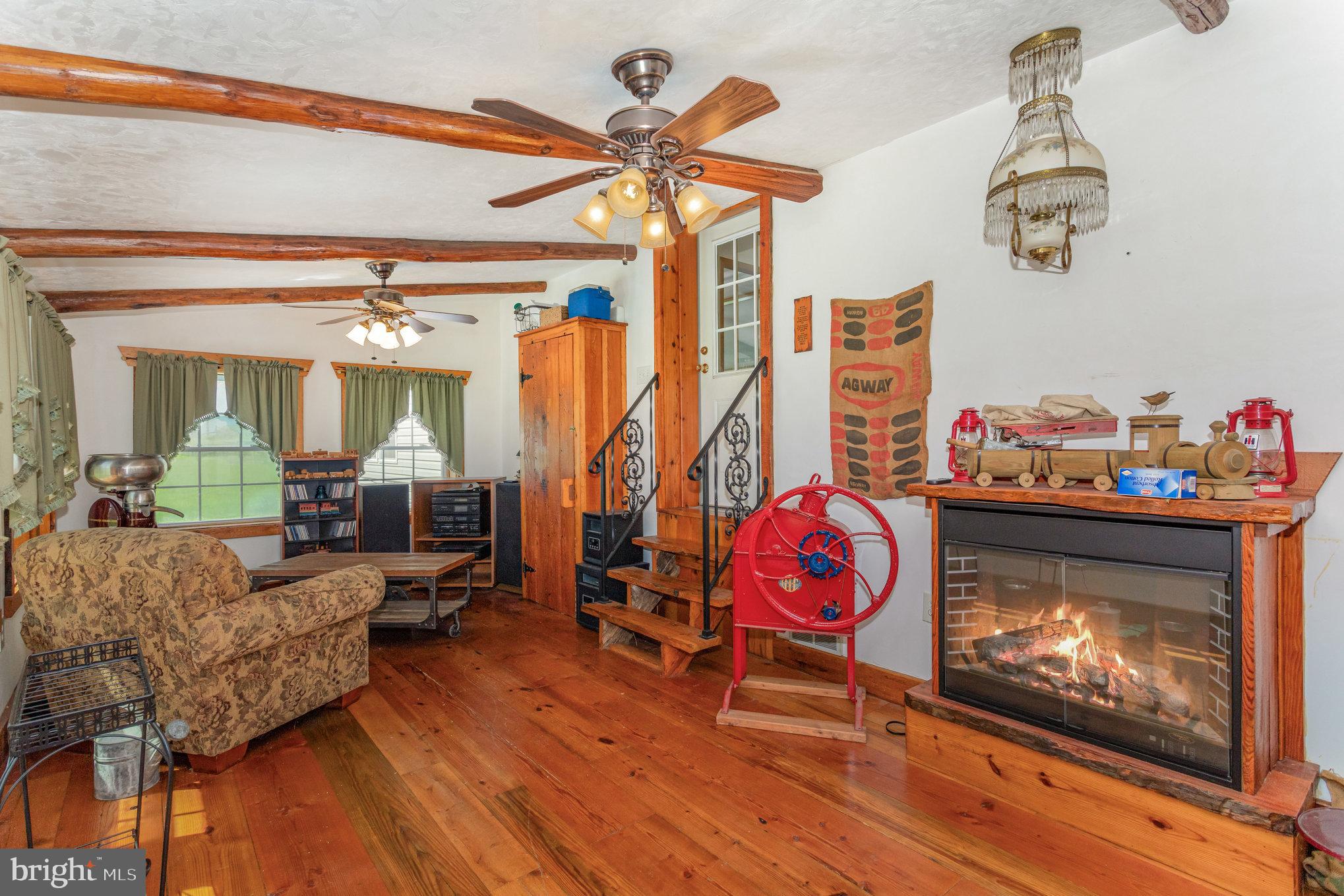 1050 Lisburn Road Wellsville, PA 17365 - Photo 14 of 35 a living room with furniture a fireplace and wooden floor