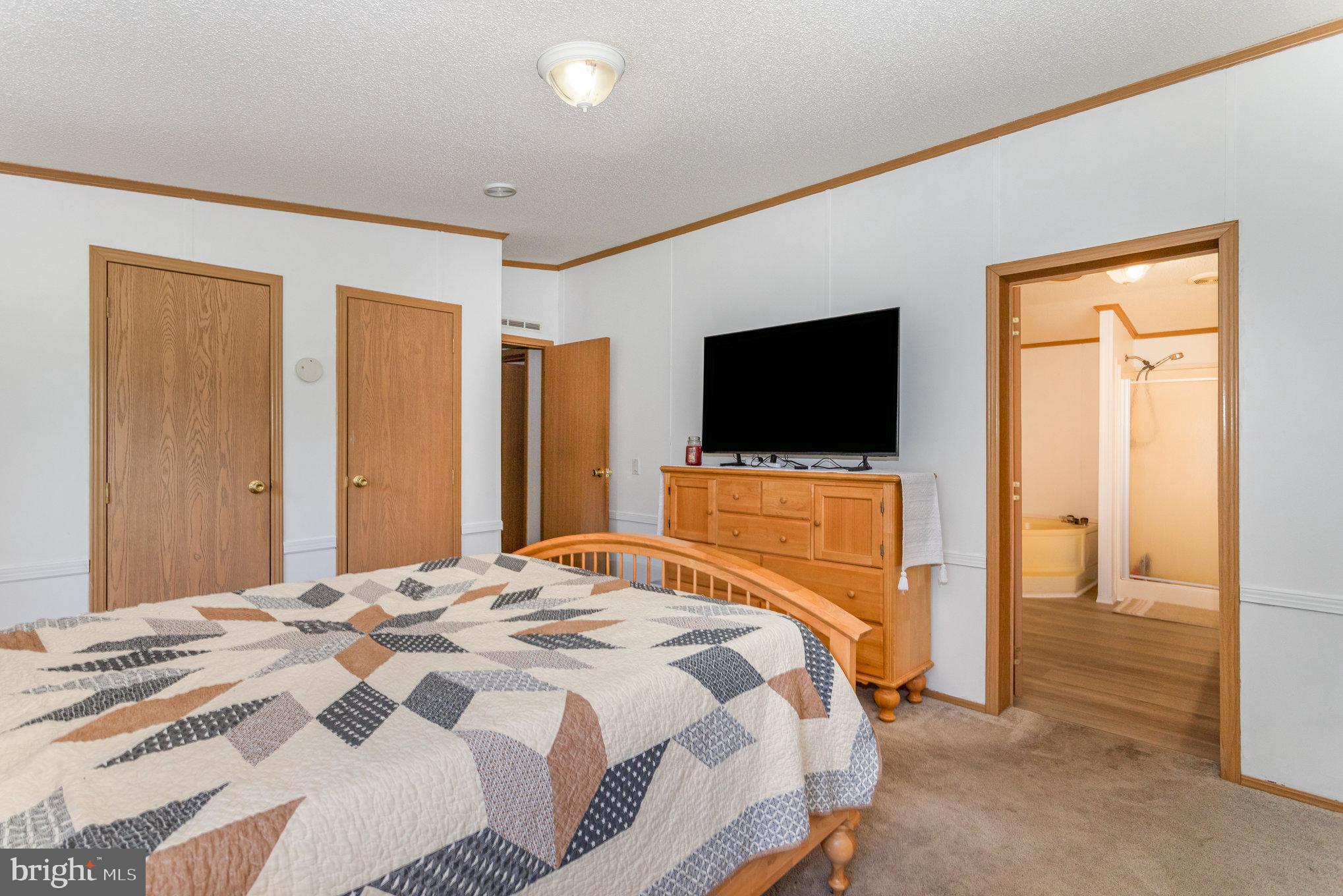 1050 Lisburn Road Wellsville, PA 17365 - Photo 16 of 35 a bedroom with a bed and a flat screen tv
