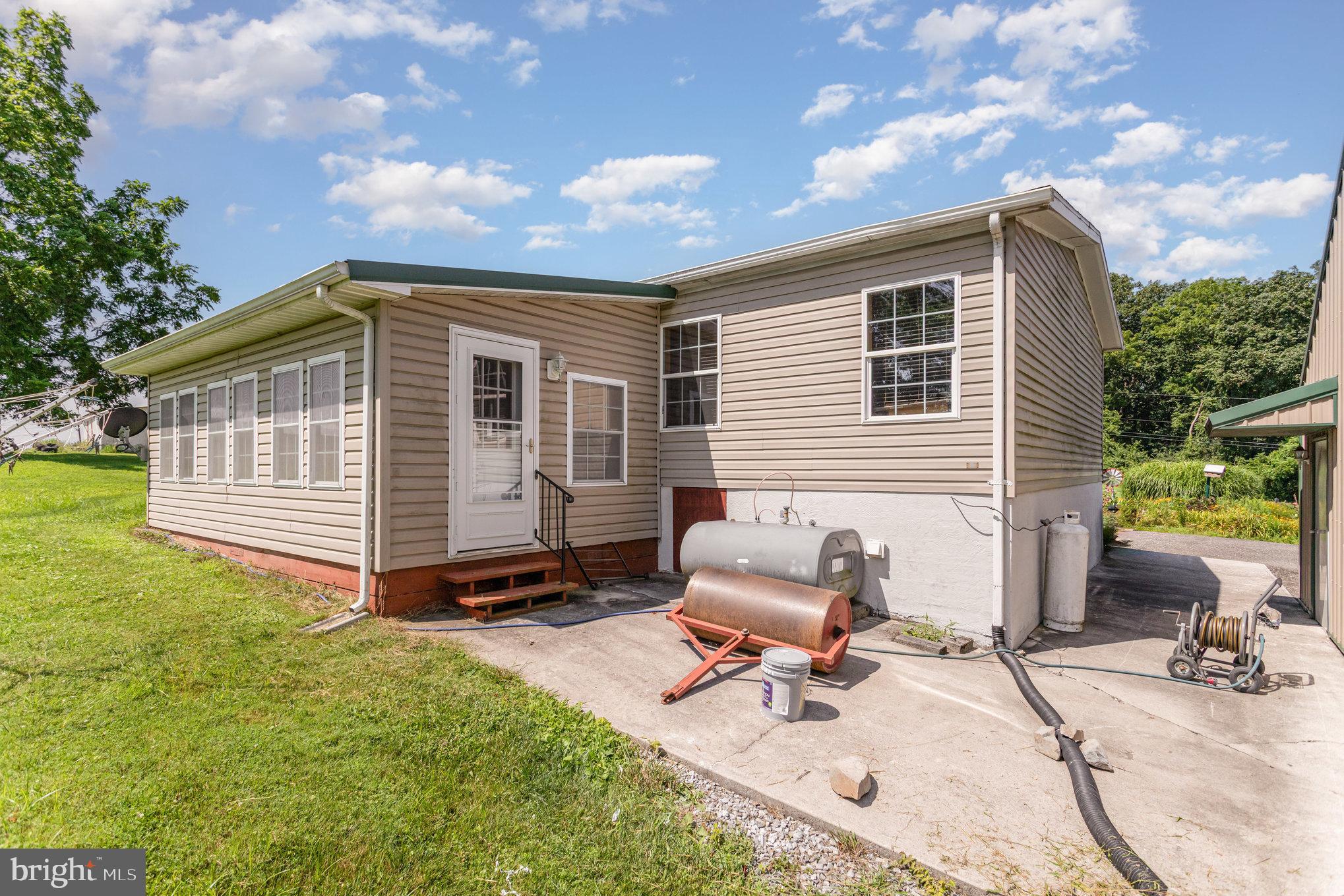 1050 Lisburn Road Wellsville, PA 17365 - Photo 26 of 35 a backyard of a house with a garden and barbeque oven