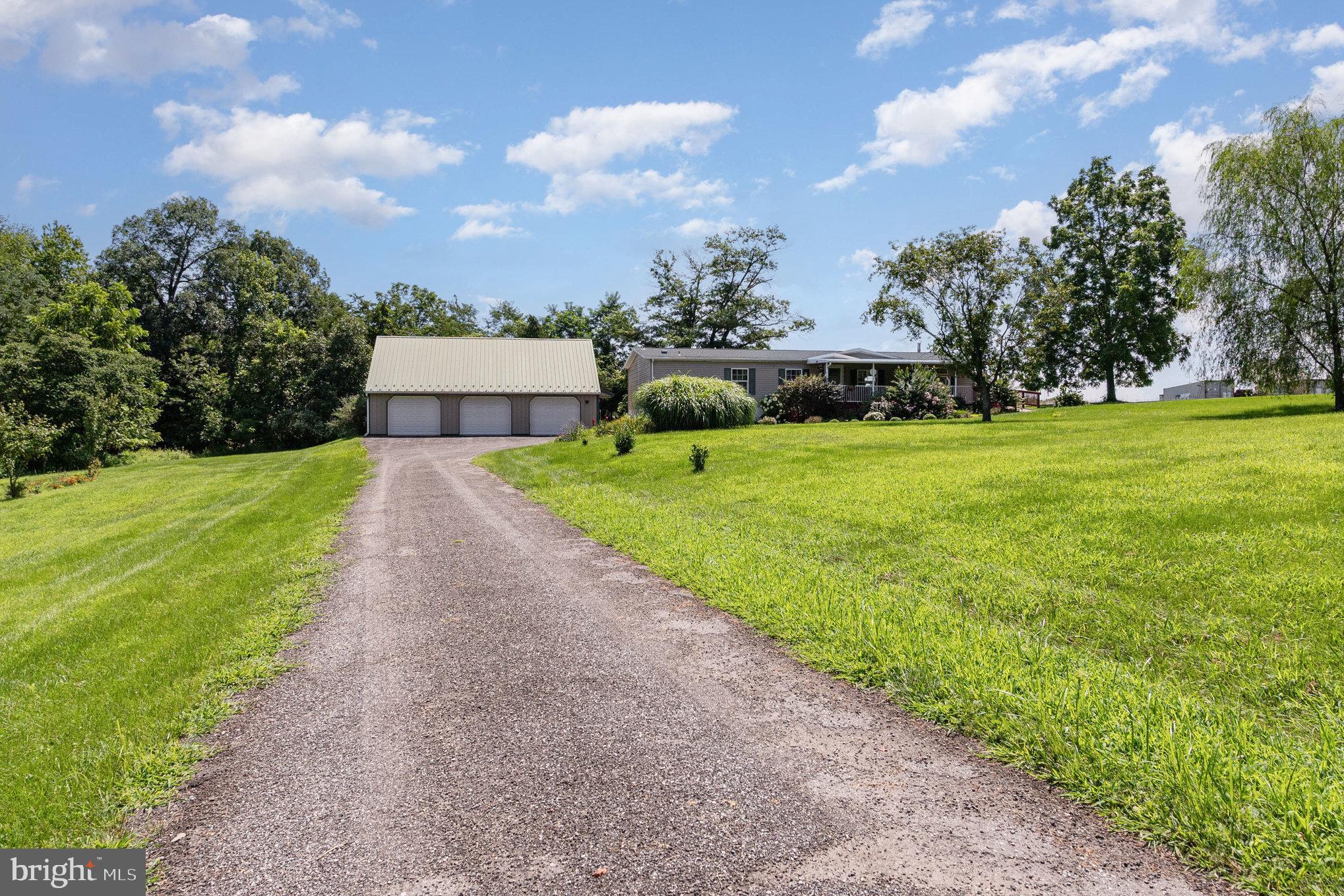1050 Lisburn Road Wellsville, PA 17365 - Photo 29 of 35 a view of a garden with a building in the background