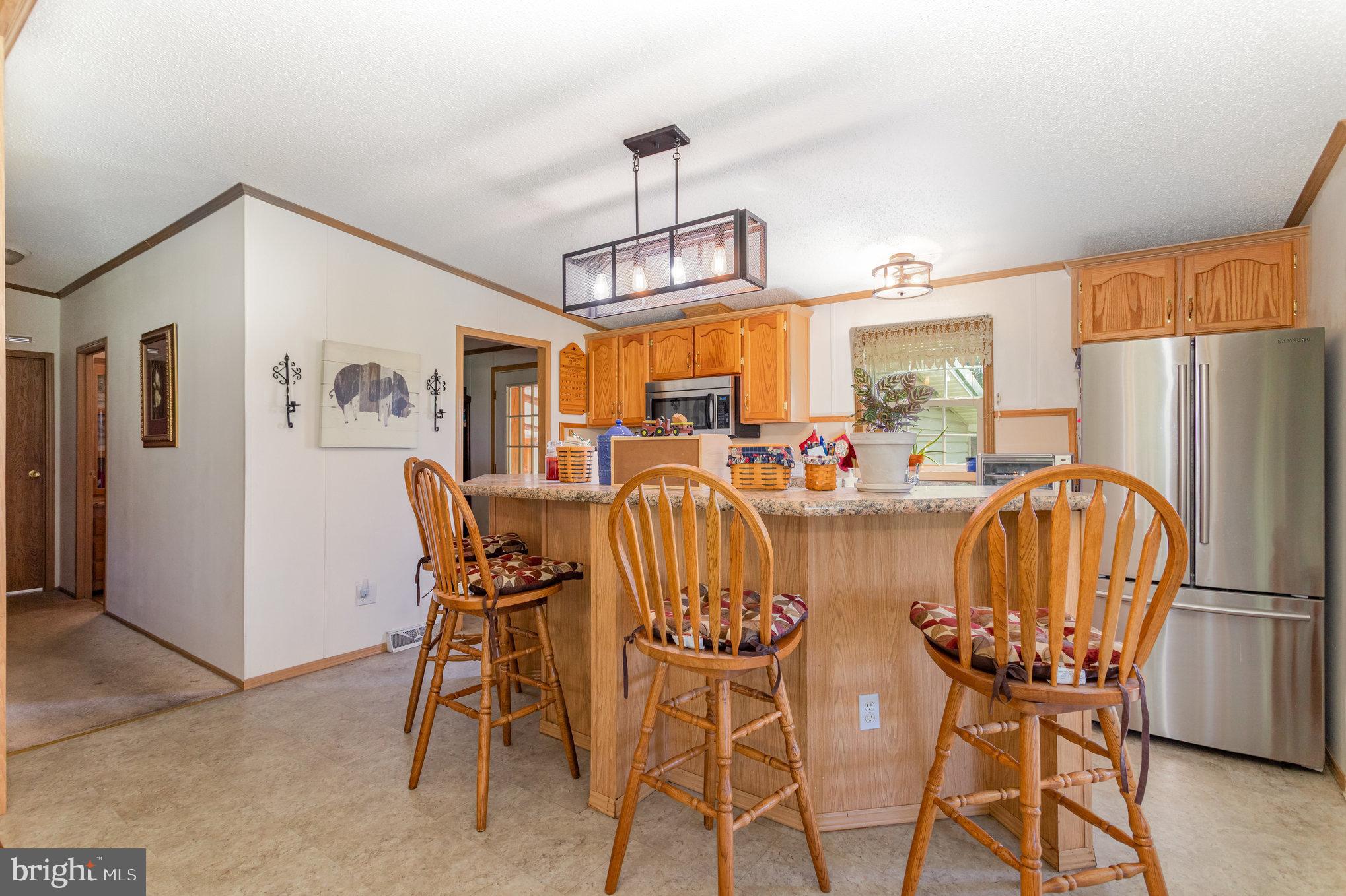 1050 Lisburn Road Wellsville, PA 17365 - Photo 10 of 35 a dining room with furniture a window and kitchen view