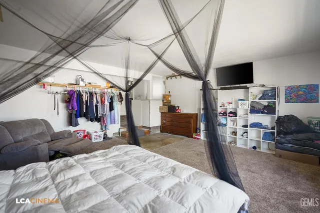 a bed room with a bed and a flat screen tv