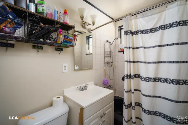 a view of a bathroom with a shower and a sink