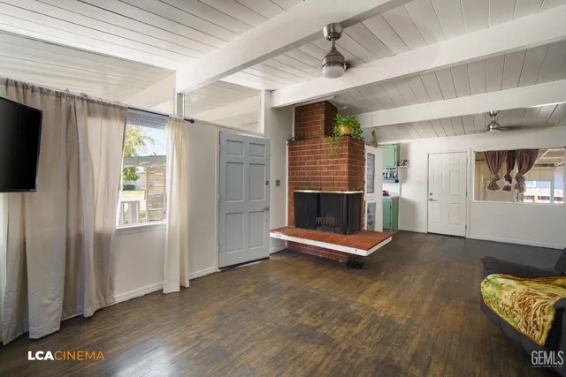 a living room with furniture gym equipment and a flat screen tv