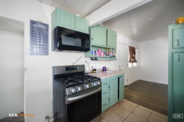 a kitchen with stainless steel appliances a stove and a microwave