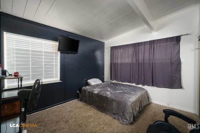 a bedroom with bed and window