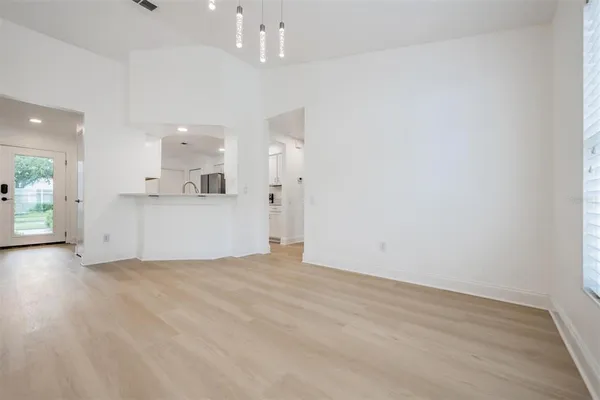 a view of a kitchen with a sink and a refrigerator