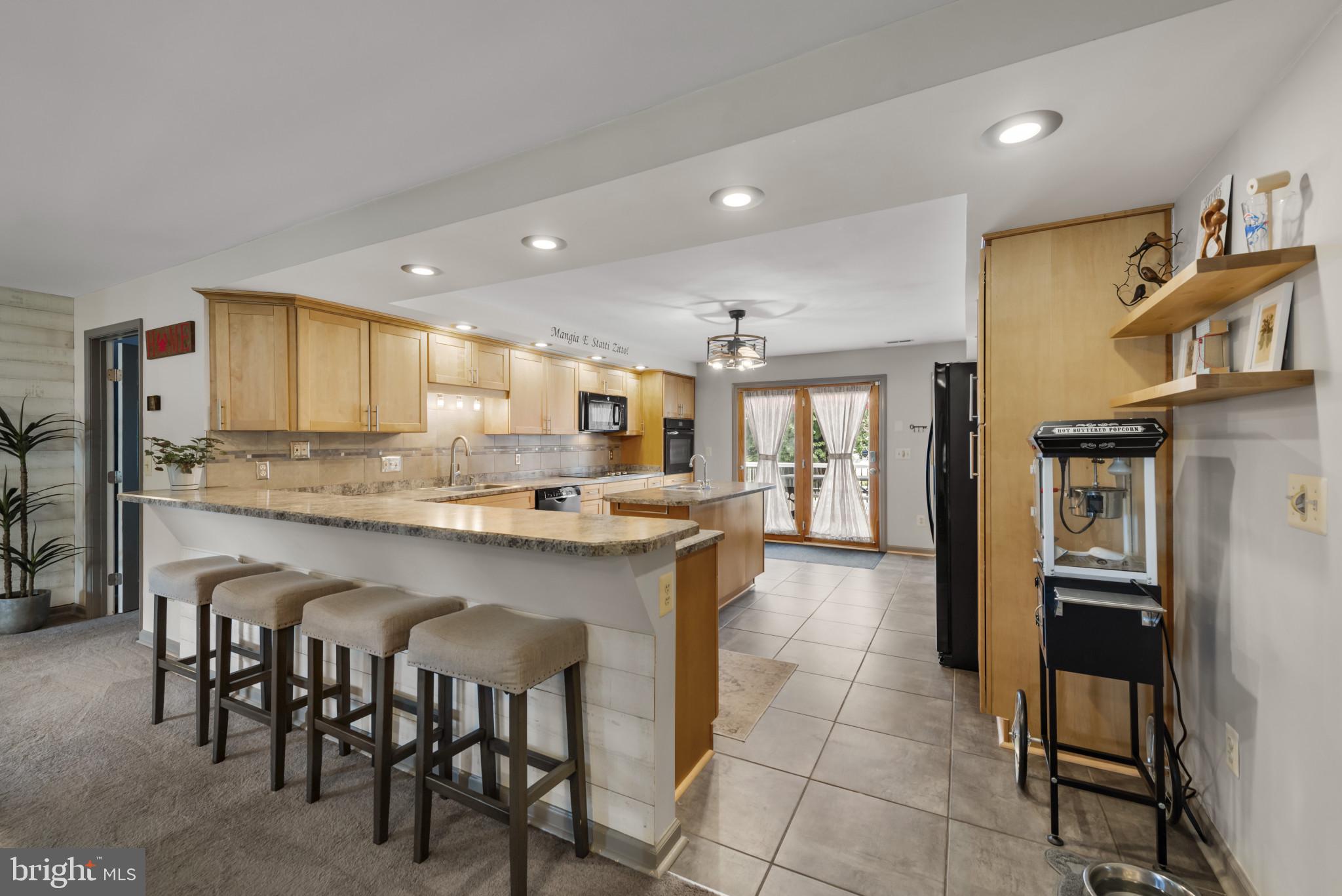332 Poplar Road Baltimore, MD 21221 - Photo 23 of 59 a large kitchen with a table and chairs in it