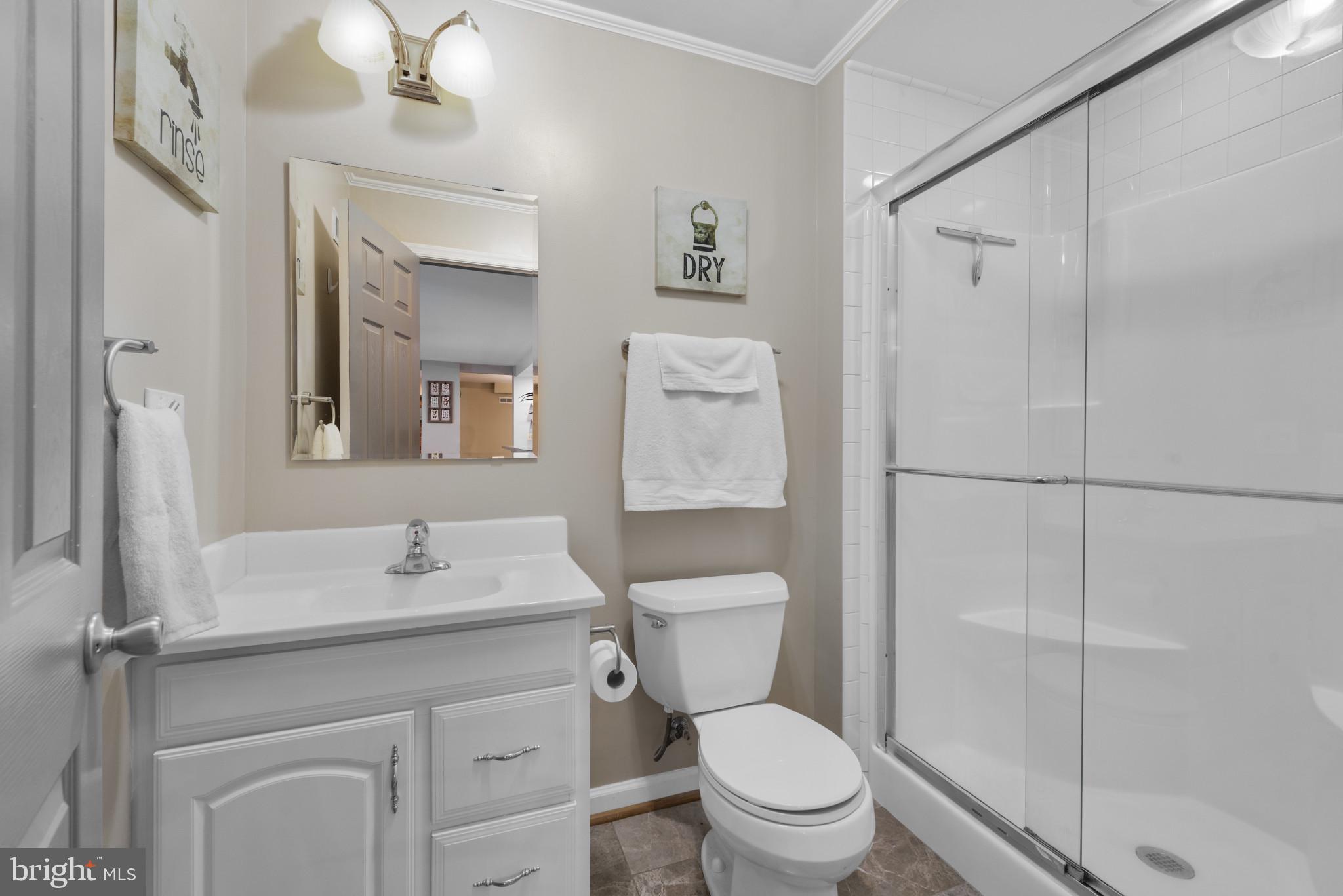 332 Poplar Road Baltimore, MD 21221 - Photo 28 of 59 a bathroom with a sink toilet vanity and shower