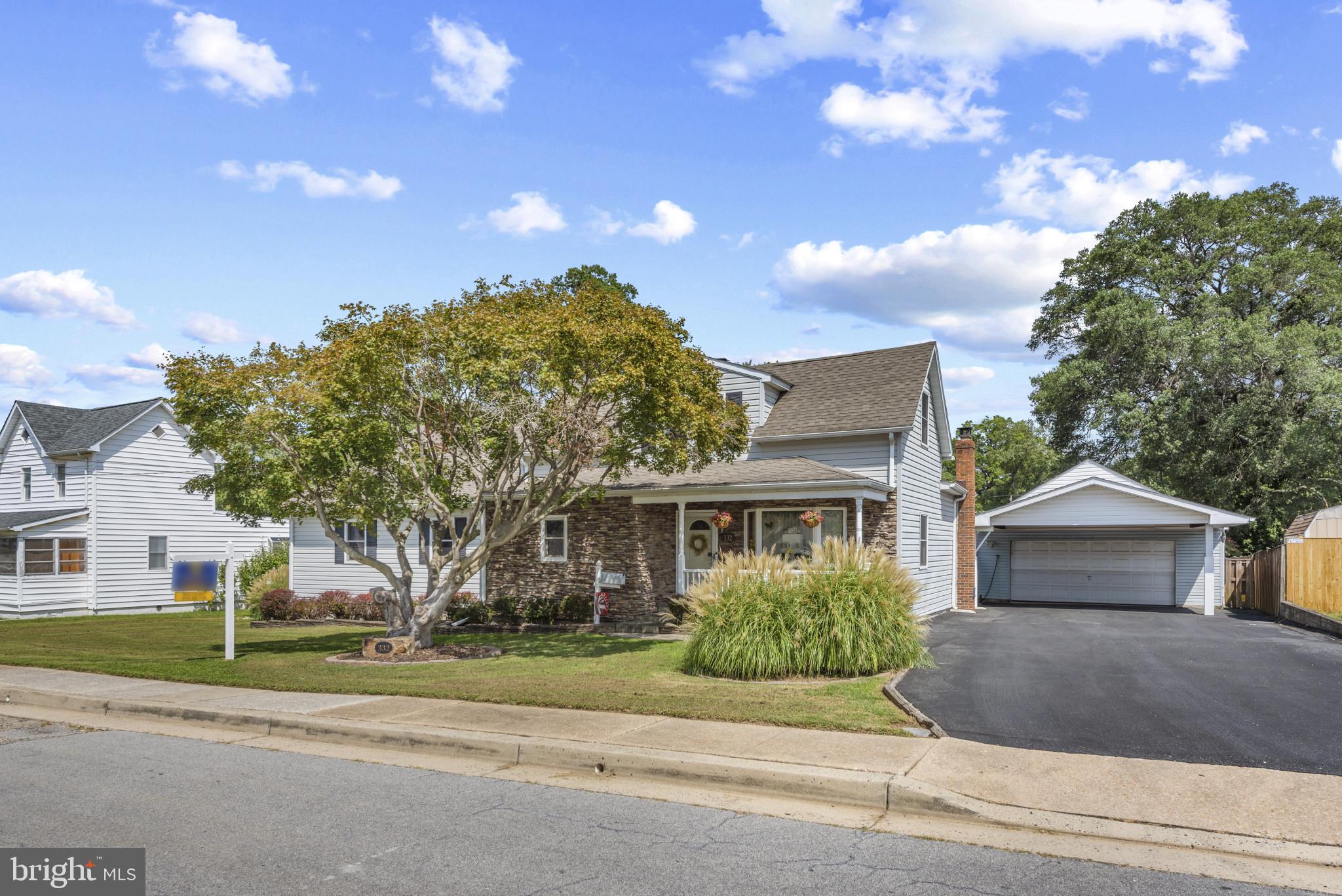 332 Poplar Road Baltimore, MD 21221 - Photo 3 of 59 a front view of a house with a garden and trees