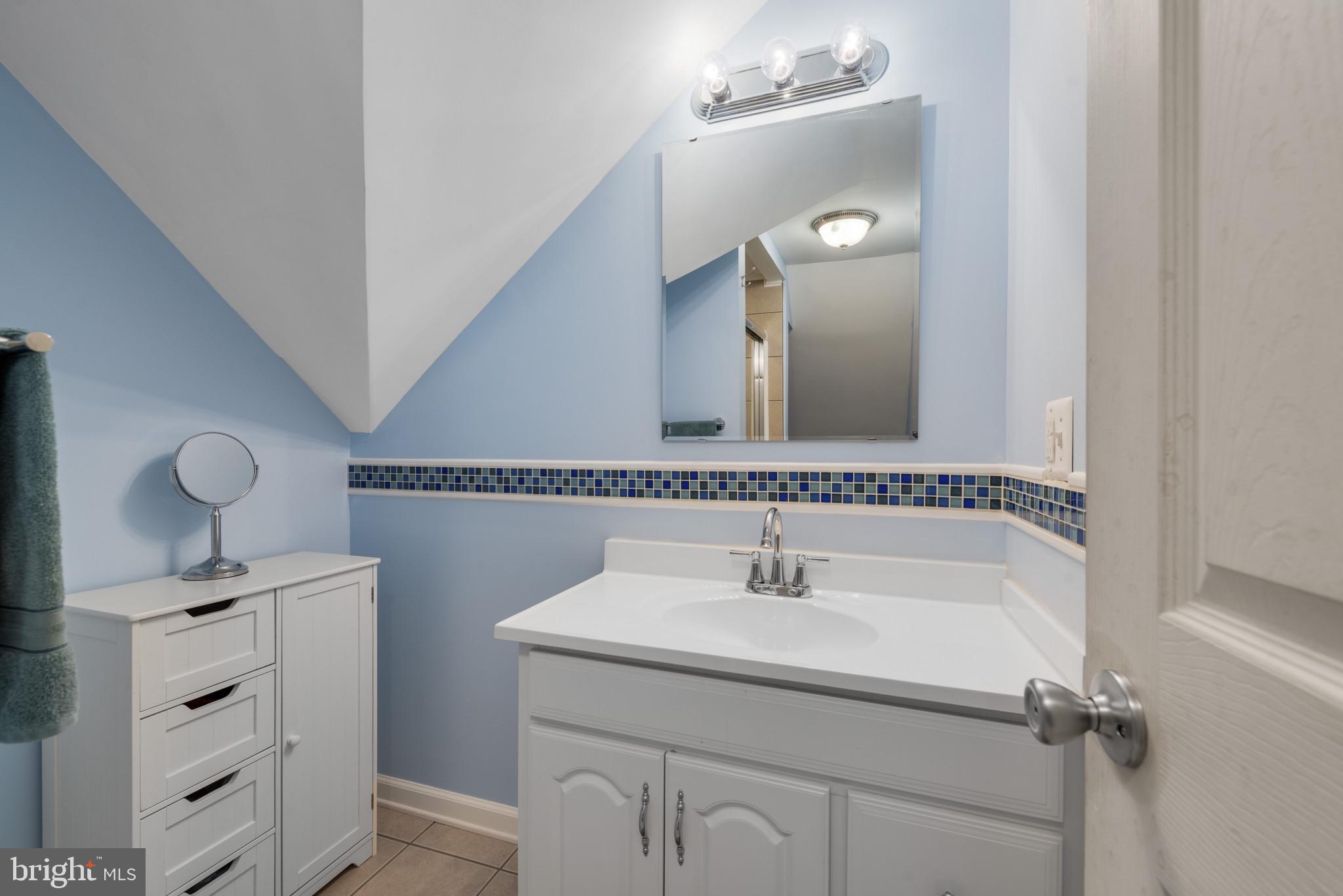 332 Poplar Road Baltimore, MD 21221 - Photo 40 of 59 a bathroom with a sink vanity and mirror