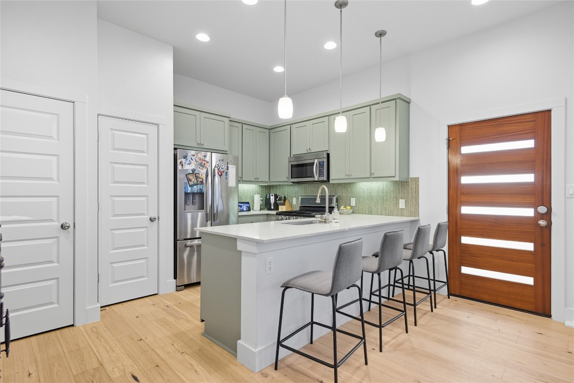 2007 South L Davis Avenue, Unit B Austin, TX 78702 - Photo 14 of 24 a kitchen with stainless steel appliances granite countertop a refrigerator and a stove top oven