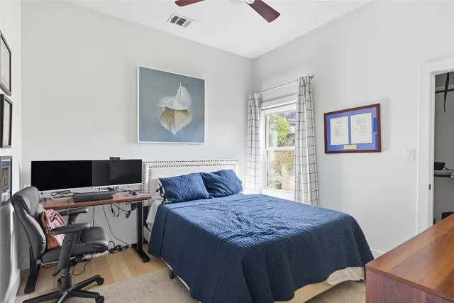 a bedroom with a bed and a painting on the wall