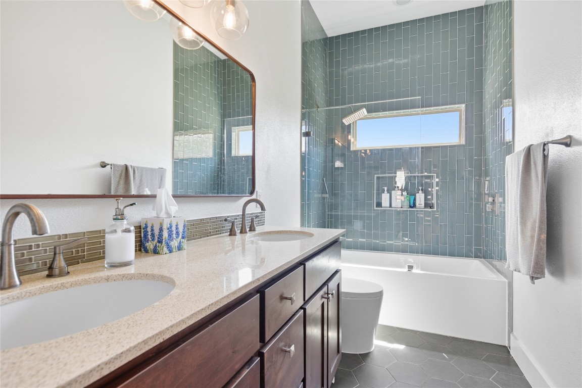 2007 South L Davis Avenue, Unit B Austin, TX 78702 - Photo 19 of 24 a bathroom with a granite countertop sink mirror and bathtub