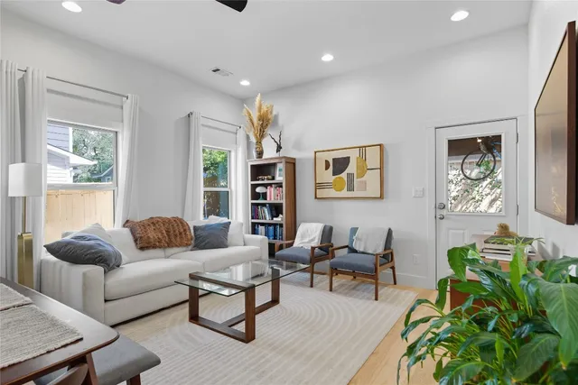 a living room with furniture and a potted plant