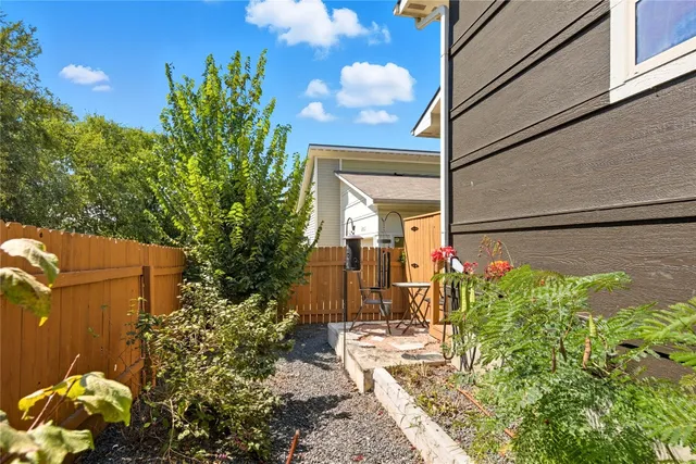 a backyard of a house with table and chairs
