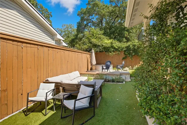 a view of backyard of house with seating space