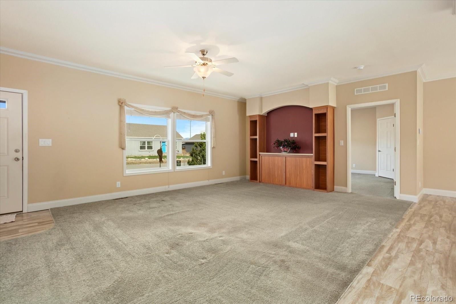 655 Quarry Station Poncha Springs, CO 81242 - Photo 3 of 41 an empty room with windows and chandelier